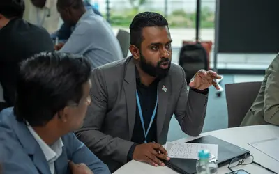 Person speaking to colleagues at the event