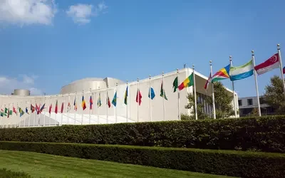 United Nations General Assembly Building with flags.