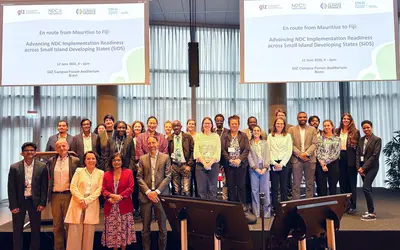 Participants stand together for a group photo at an event.
