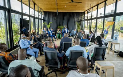 Participants take part in a group discussion at the NDCs 3.0 Regional Forum for Africa in Kigali, Rwanda, in October 2024, with one participant speaking to the group.