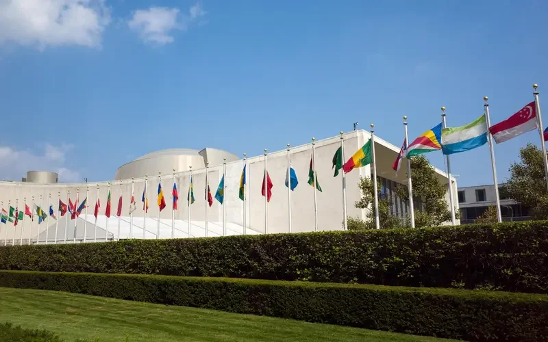 United Nations General Assembly Building with flags.