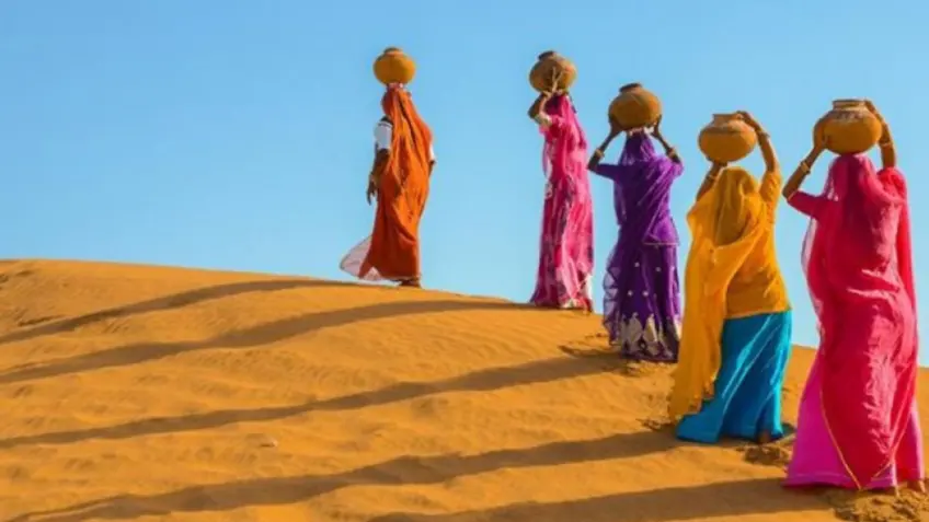 Women carrying water in the desert