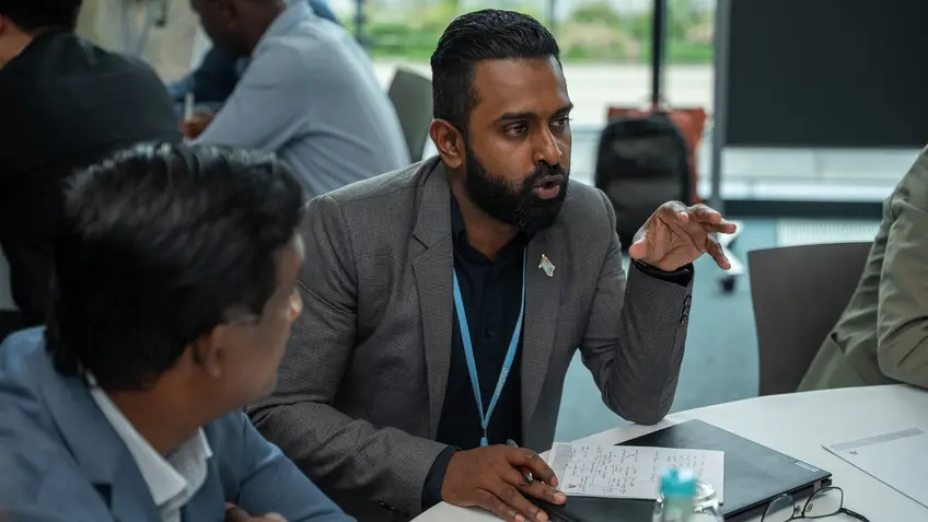 Person speaking to colleagues at the event