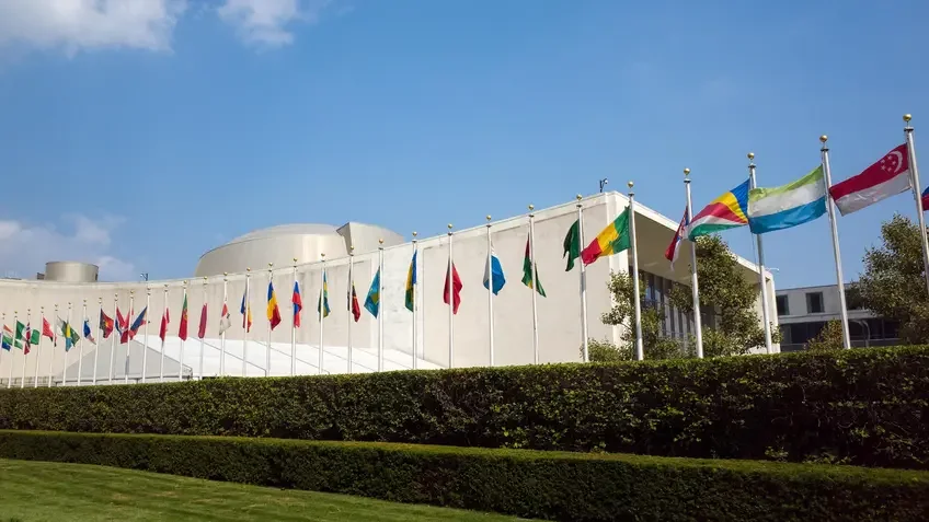 United Nations General Assembly Building with flags.