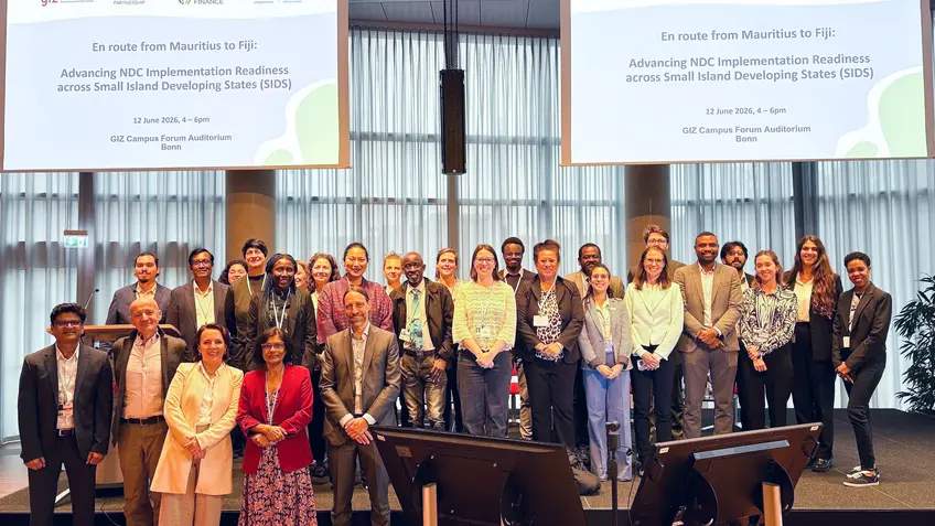 Participants stand together for a group photo at an event.