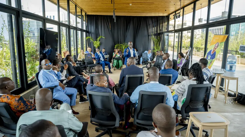 Participants take part in a group discussion at the NDCs 3.0 Regional Forum for Africa in Kigali, Rwanda, in October 2024, with one participant speaking to the group.
