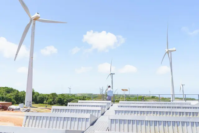 Wind turbines at the Wigton Windfarm in Jamaica against a clear blue sky.