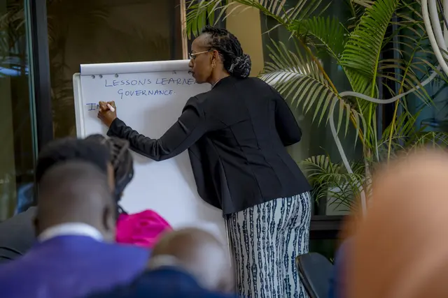 Participant writes notes on a flip chart during a breakout session at the NDCs 3.0 Forum for Africa in Rwanda in 2024.